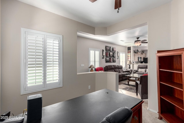 home office featuring light colored carpet and ceiling fan