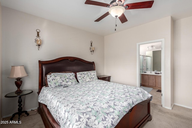 bedroom with connected bathroom, ceiling fan, and light carpet