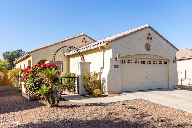 mediterranean / spanish-style house with a garage