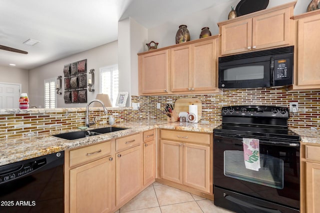 kitchen with black appliances, sink, light brown cabinetry, and tasteful backsplash