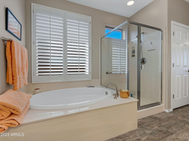 bathroom featuring a garden tub and a shower stall