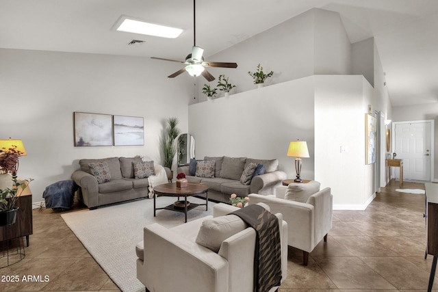 living room with ceiling fan, dark tile patterned flooring, and high vaulted ceiling