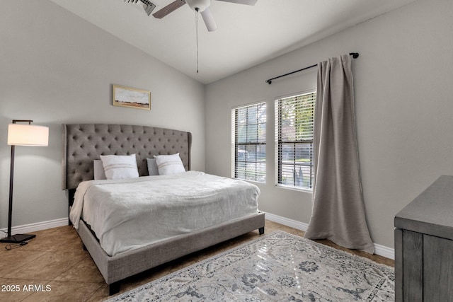 tiled bedroom with ceiling fan and vaulted ceiling