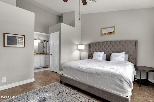 tiled bedroom with ceiling fan, lofted ceiling, and connected bathroom