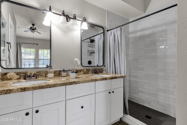 bathroom featuring vanity, ceiling fan, and walk in shower