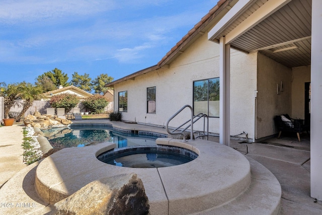 view of pool featuring an in ground hot tub and a patio area