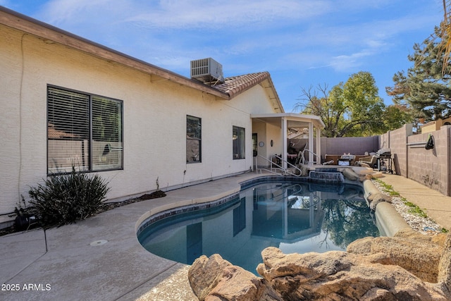 view of pool featuring a patio and central air condition unit