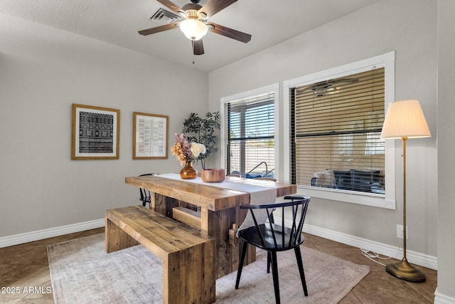 tiled dining area featuring ceiling fan