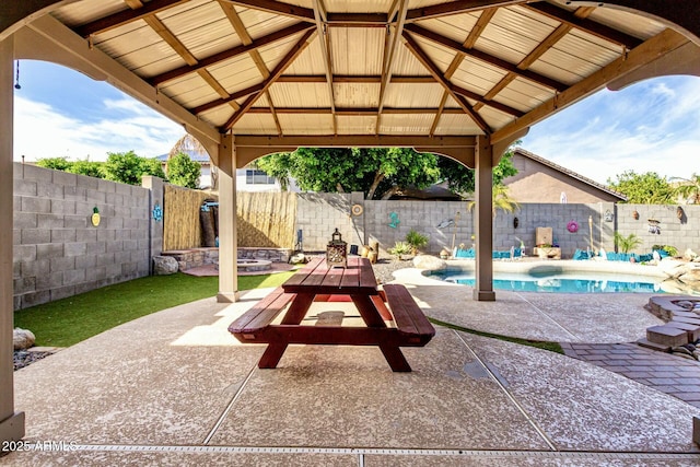 view of patio with a fenced backyard, a gazebo, and a fenced in pool