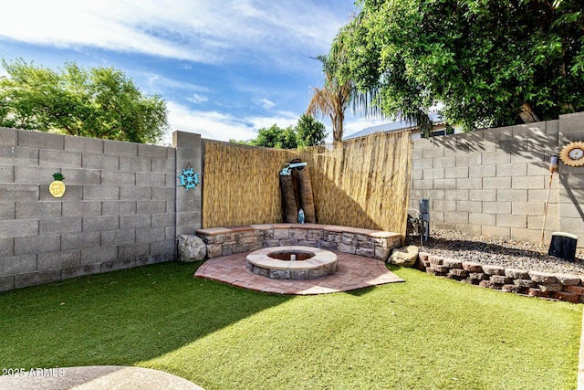 view of yard featuring a fenced backyard, a patio area, and an outdoor fire pit