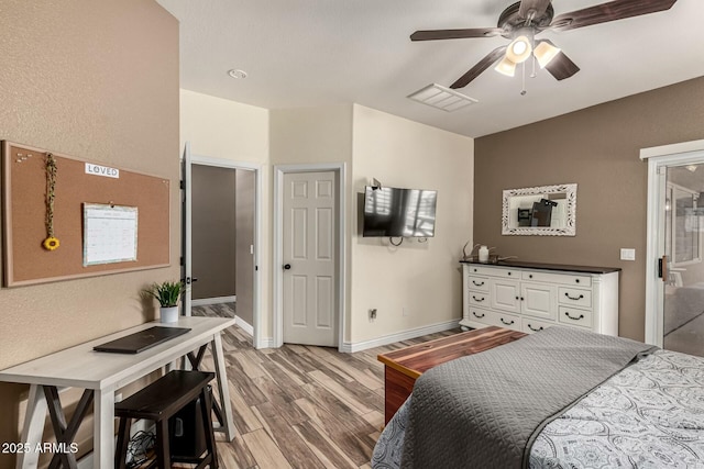 bedroom with visible vents, baseboards, a ceiling fan, and wood finished floors