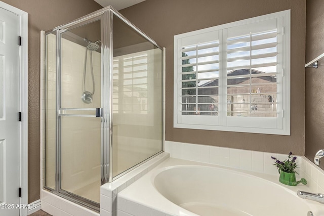 bathroom with a bath and a stall shower