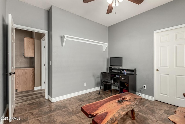 home office featuring a ceiling fan and baseboards