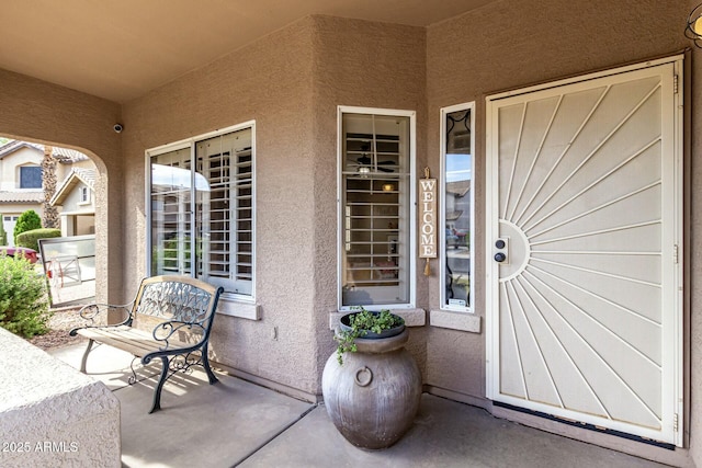 entrance to property with stucco siding