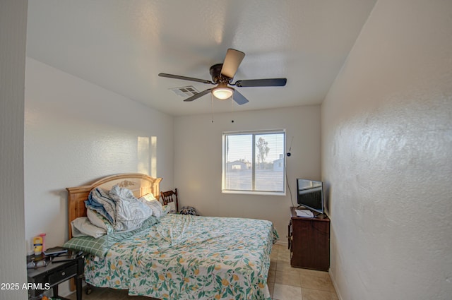 bedroom featuring light tile patterned flooring, visible vents, and ceiling fan