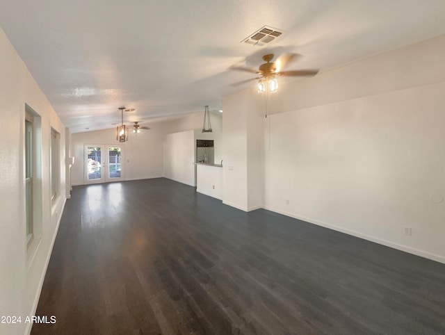 unfurnished living room featuring dark wood-type flooring, vaulted ceiling, french doors, and ceiling fan