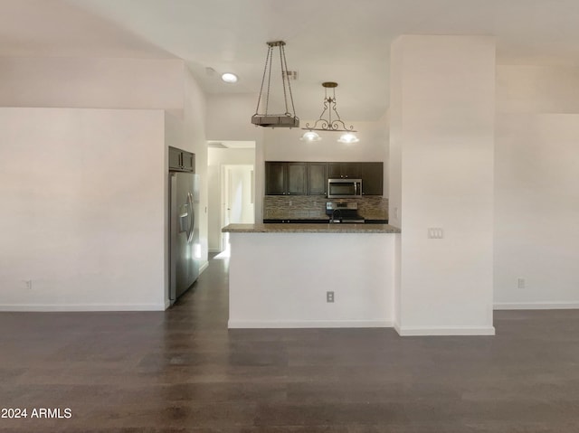 kitchen with tasteful backsplash, dark hardwood / wood-style flooring, stainless steel appliances, light stone countertops, and decorative light fixtures