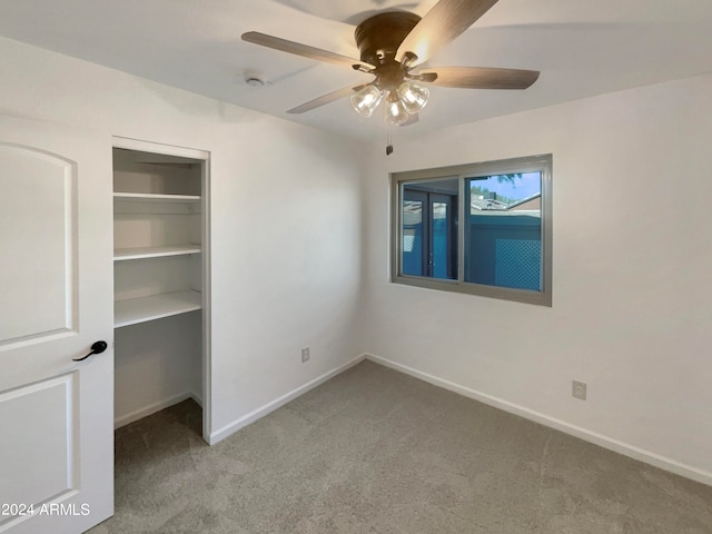 unfurnished bedroom with carpet floors, ceiling fan, and a closet