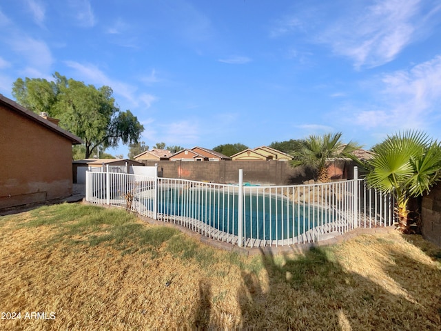 view of swimming pool featuring a lawn