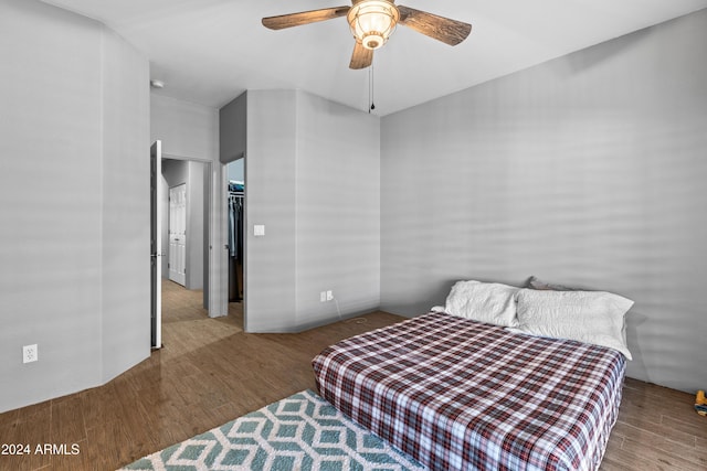 bedroom featuring ceiling fan, a closet, and light wood-type flooring