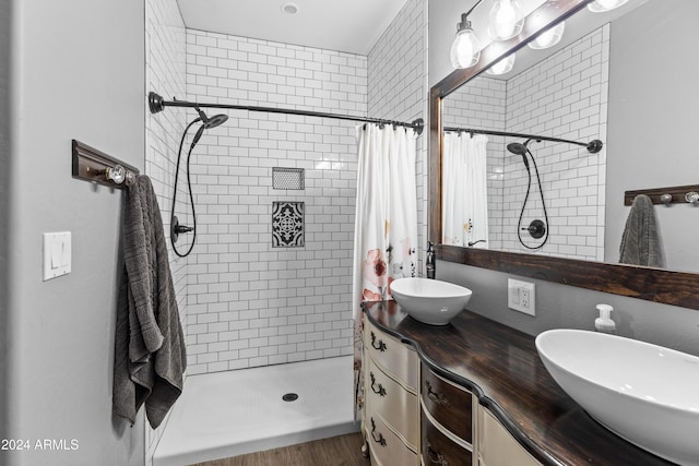 bathroom featuring walk in shower and vanity