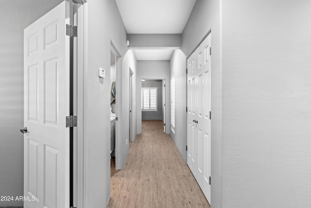 hallway with light hardwood / wood-style flooring