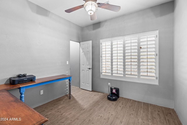 misc room with ceiling fan and light hardwood / wood-style floors