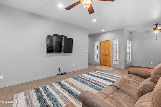 living room featuring ceiling fan and light hardwood / wood-style flooring