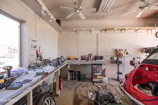 garage with a workshop area and ceiling fan