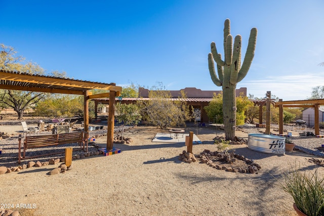 view of yard with a fire pit and a pergola