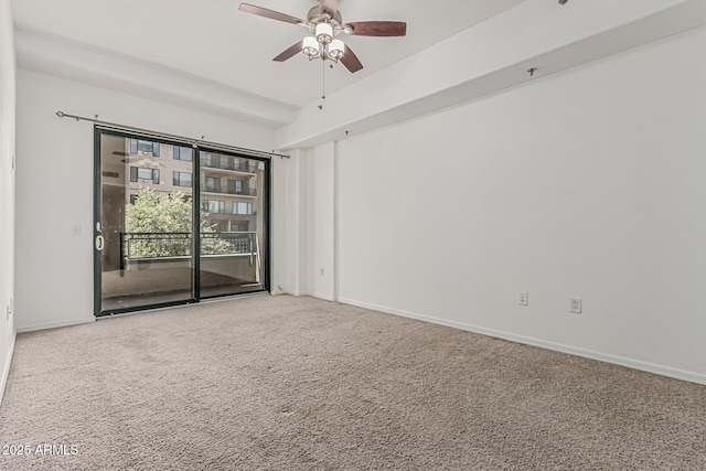 empty room with carpet floors, a ceiling fan, and baseboards
