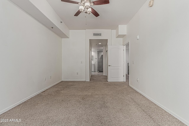 unfurnished bedroom with ceiling fan, visible vents, baseboards, ensuite bathroom, and carpet