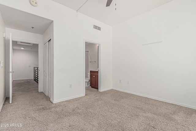 unfurnished bedroom featuring connected bathroom, baseboards, visible vents, and light carpet