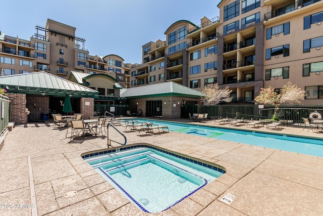 pool featuring a patio, a gazebo, fence, and a community hot tub