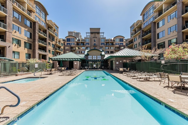 community pool featuring a gazebo, a patio area, and fence
