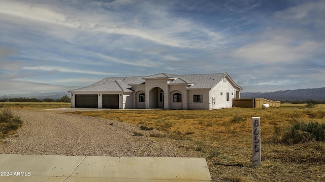 view of front of home featuring a mountain view and a garage