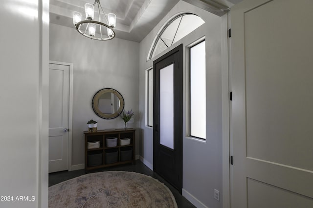 foyer entrance featuring a healthy amount of sunlight and an inviting chandelier