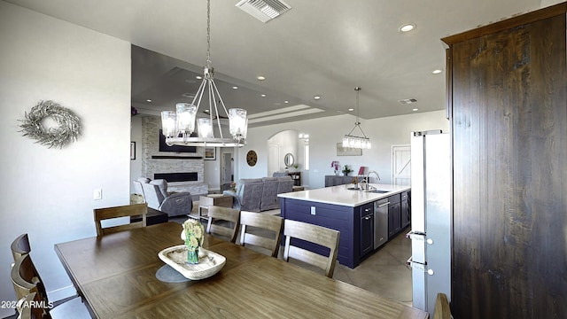 dining area featuring a fireplace and sink