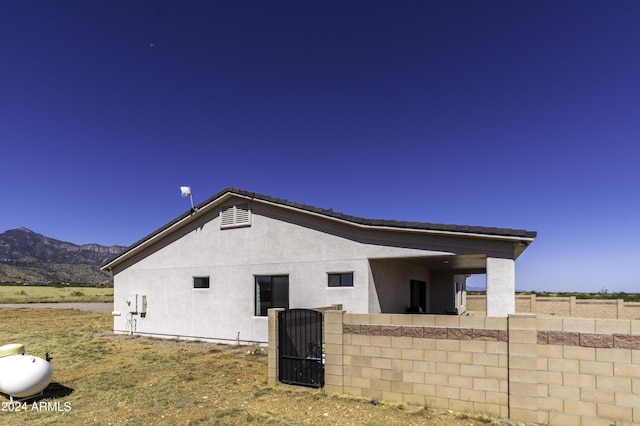 view of side of home featuring a mountain view