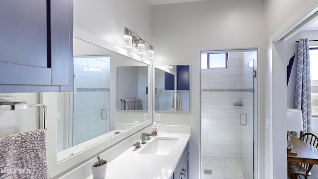 bathroom with vanity and a shower with shower door