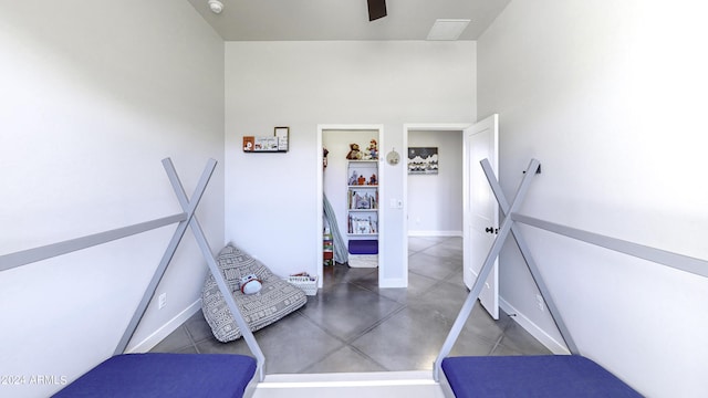 stairs featuring concrete flooring and a high ceiling