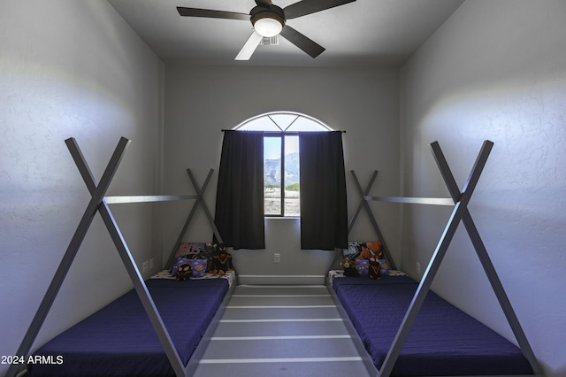 interior space with ceiling fan