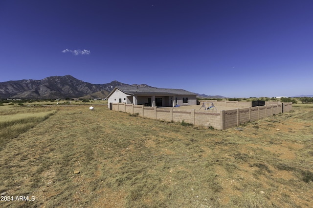 view of yard with a mountain view and a rural view