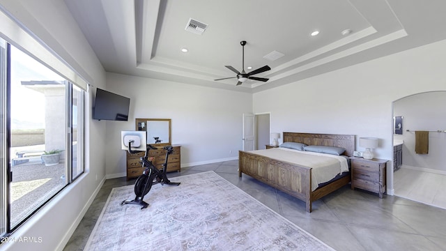 bedroom with a raised ceiling and ceiling fan