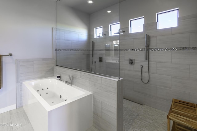 bathroom with tile patterned flooring and shower with separate bathtub