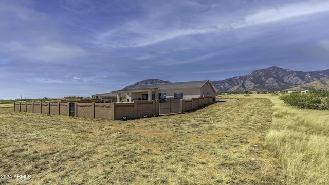 view of yard with a mountain view and a rural view