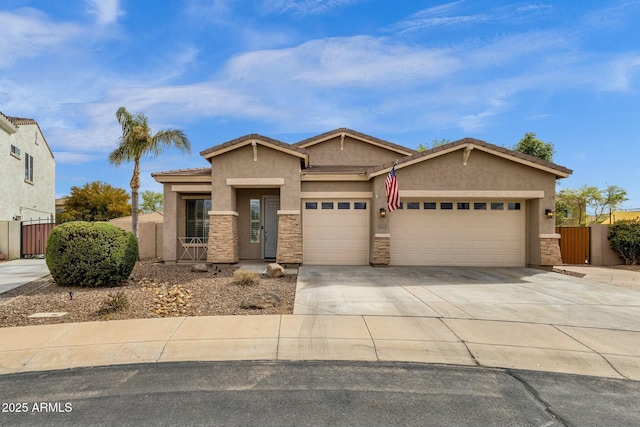 view of front facade featuring stucco siding, concrete driveway, an attached garage, and a gate