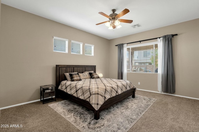 carpeted bedroom featuring visible vents, ceiling fan, and baseboards