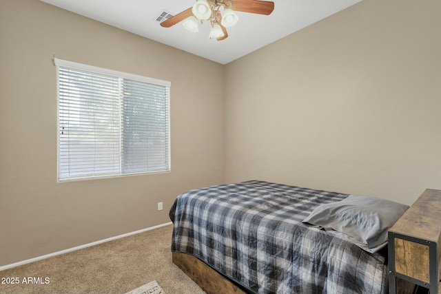 carpeted bedroom with visible vents, baseboards, and ceiling fan