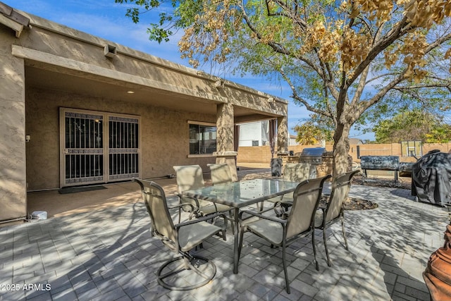 deck featuring a patio area, outdoor dining space, and an outdoor kitchen